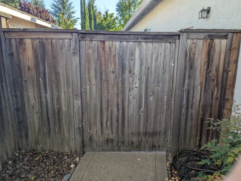Fence section and gate before replacement