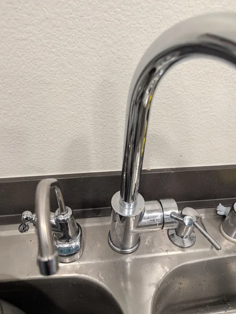 Under-sink water filter with dedicated faucet and soap dispenser