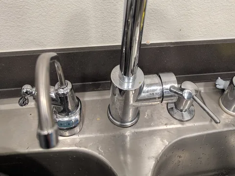 Under-sink water filter, dedicated faucet and soap dispenser installed